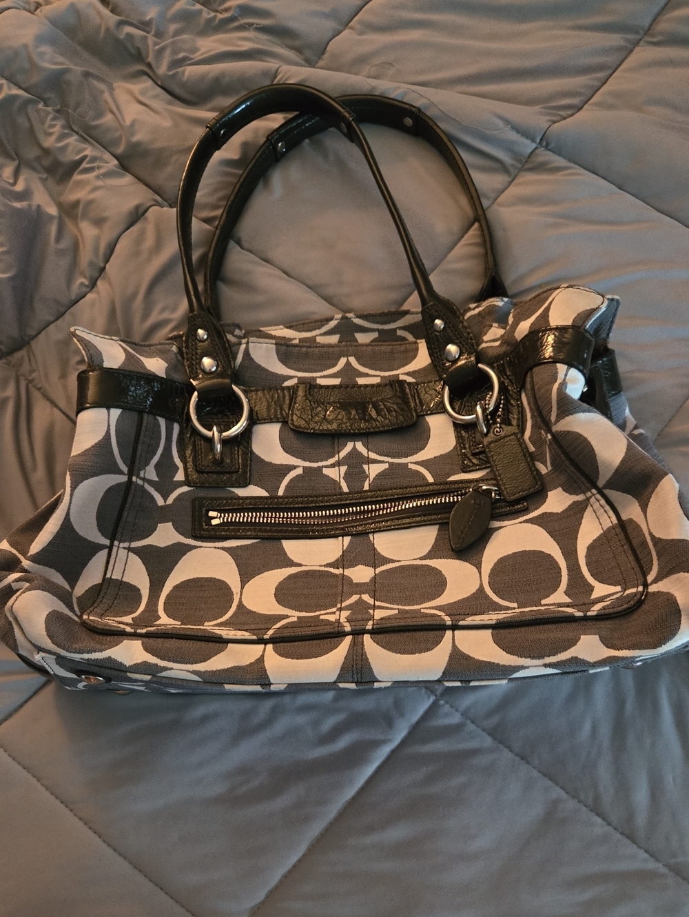 Coach Penelope Signature handbag featuring black patent leather trim Demin